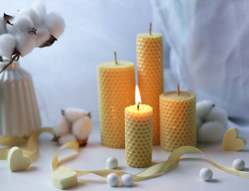 Warm and cozy candlelight scene with aromatic beeswax candles and soft cotton decor, creating a tranquil atmosphere.